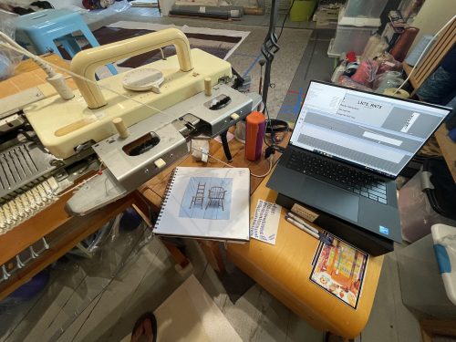 Knitting machine set up with computer.